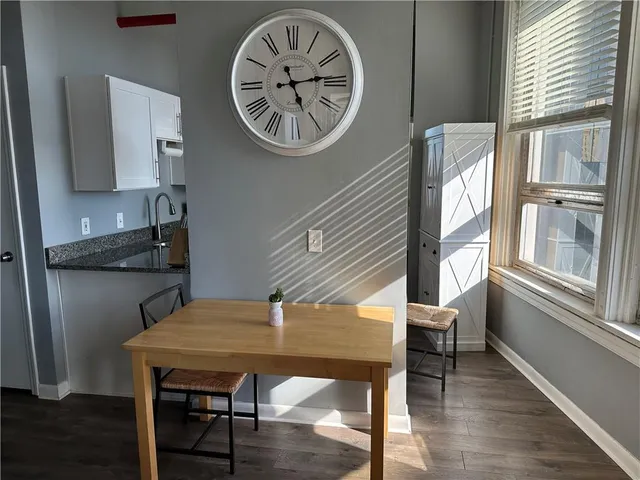 a view of a dining room with furniture window and wooden floor
