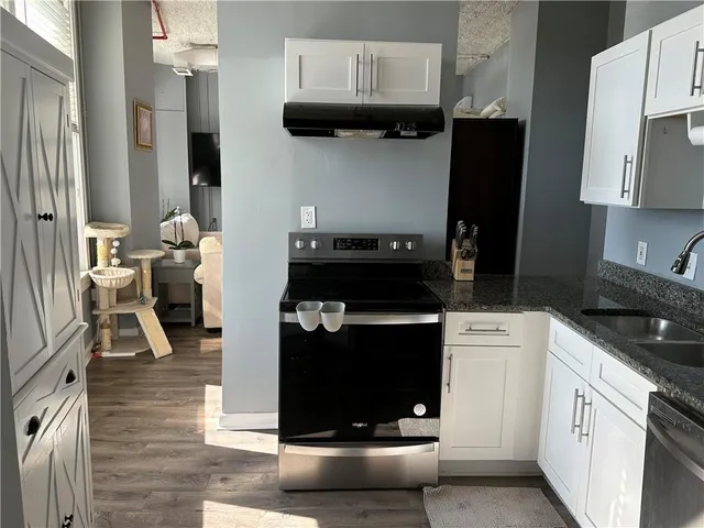 a kitchen with a stove and a refrigerator