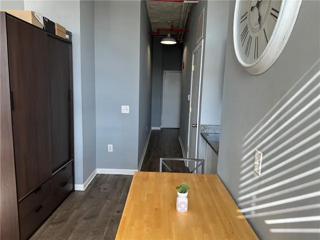 a view of a hallway with wooden floor
