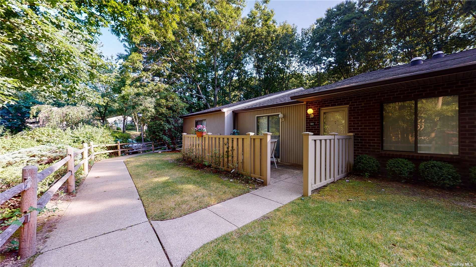 168 Birchwood Road, Unit 652 Coram, NY 11727 - Photo 1 of 1 a view of a back yard with patio