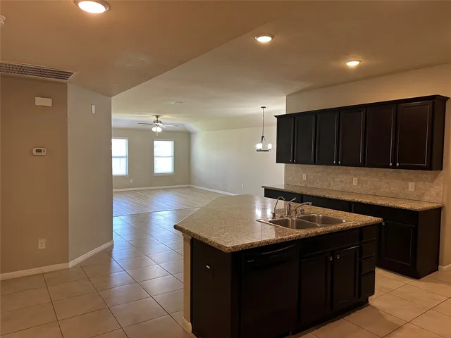 a kitchen with a sink and cabinets