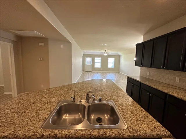 a kitchen with a sink a stove and cabinets