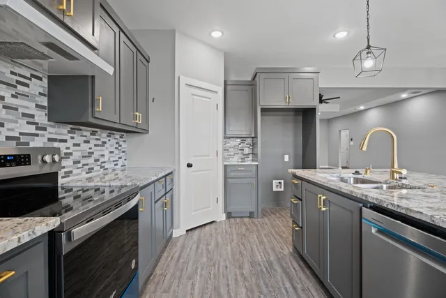 a kitchen with a sink stove and cabinets