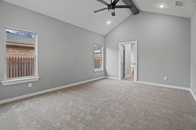 a view of a livingroom with a ceiling fan and window