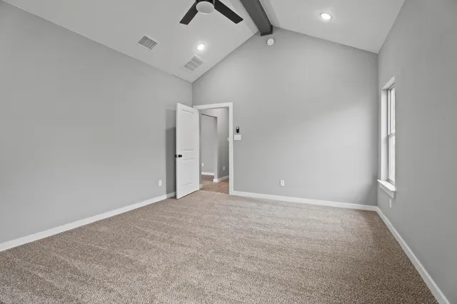 en empty room with fan and a ceiling fan