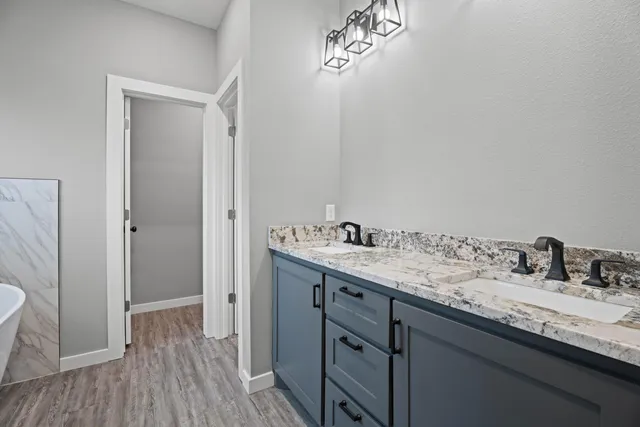 a bathroom with a double vanity sink and mirror