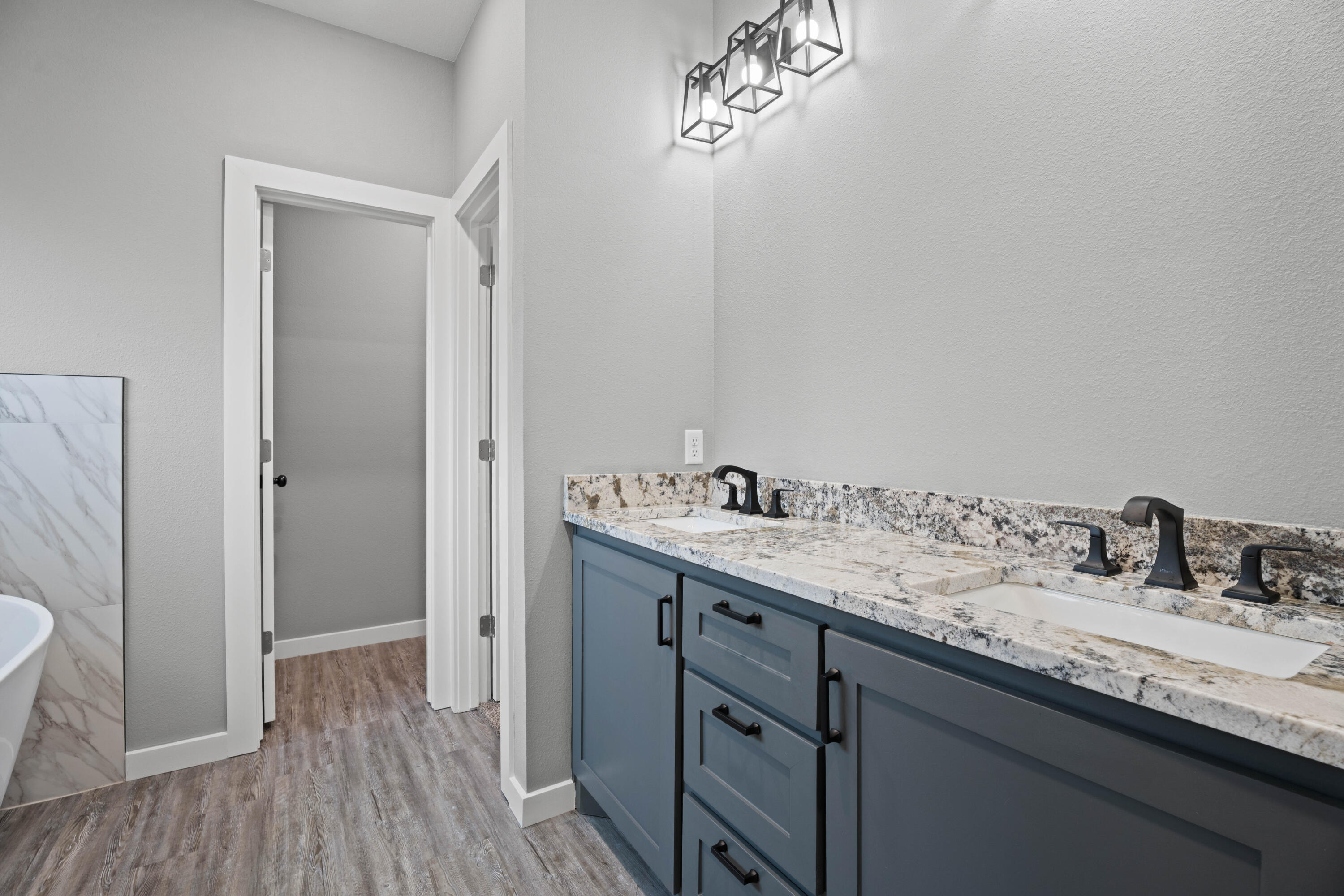 310 East 16th Street Wolfforth, TX 79382 - Photo 16 of 30 a bathroom with a double vanity sink and mirror