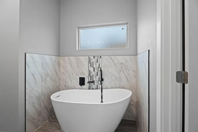 a white bath tub sitting in a bathroom