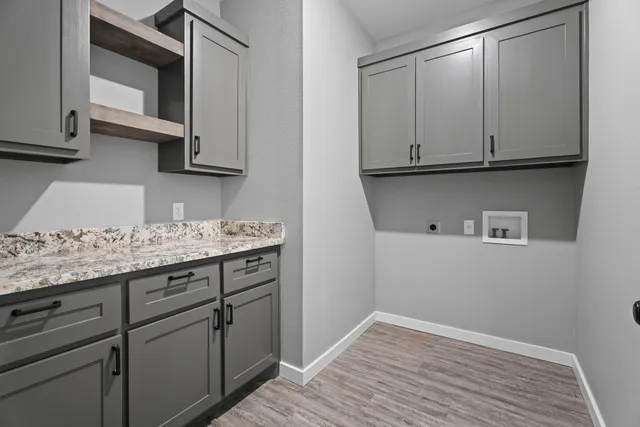 a kitchen with granite countertop white cabinets and sink