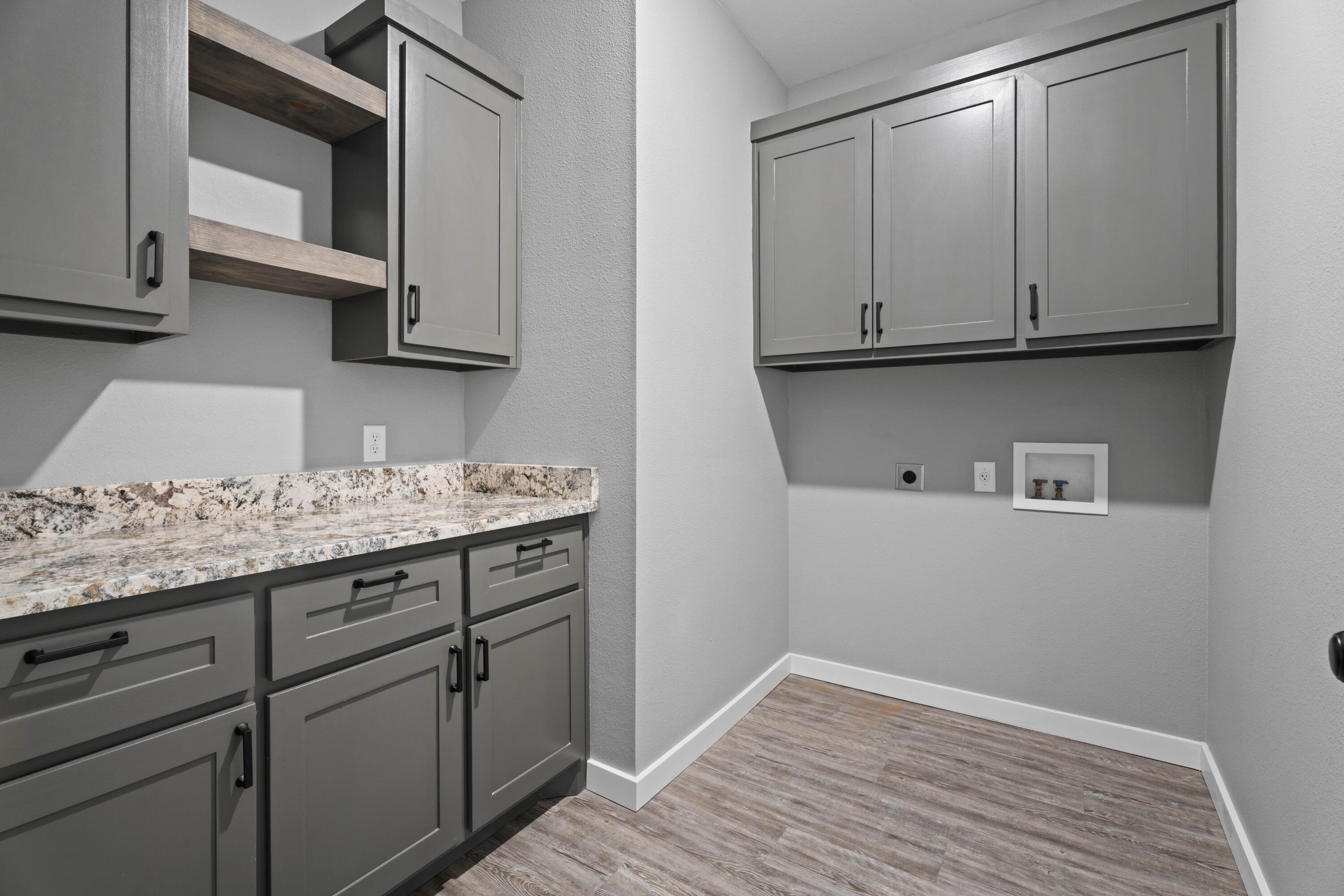 310 East 16th Street Wolfforth, TX 79382 - Photo 20 of 30 a kitchen with granite countertop white cabinets and sink