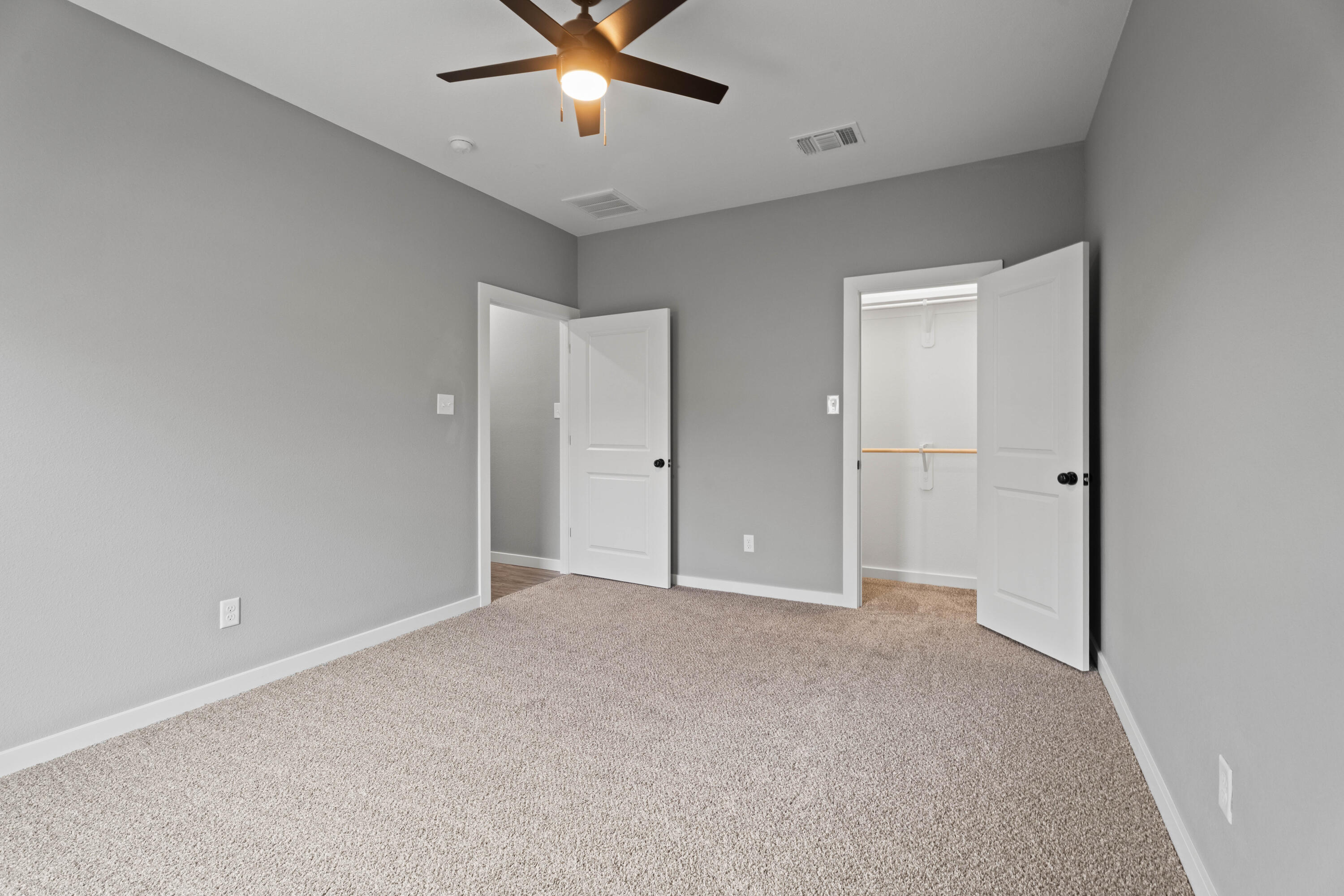 310 East 16th Street Wolfforth, TX 79382 - Photo 22 of 30 an empty room with closet and a chandelier fan