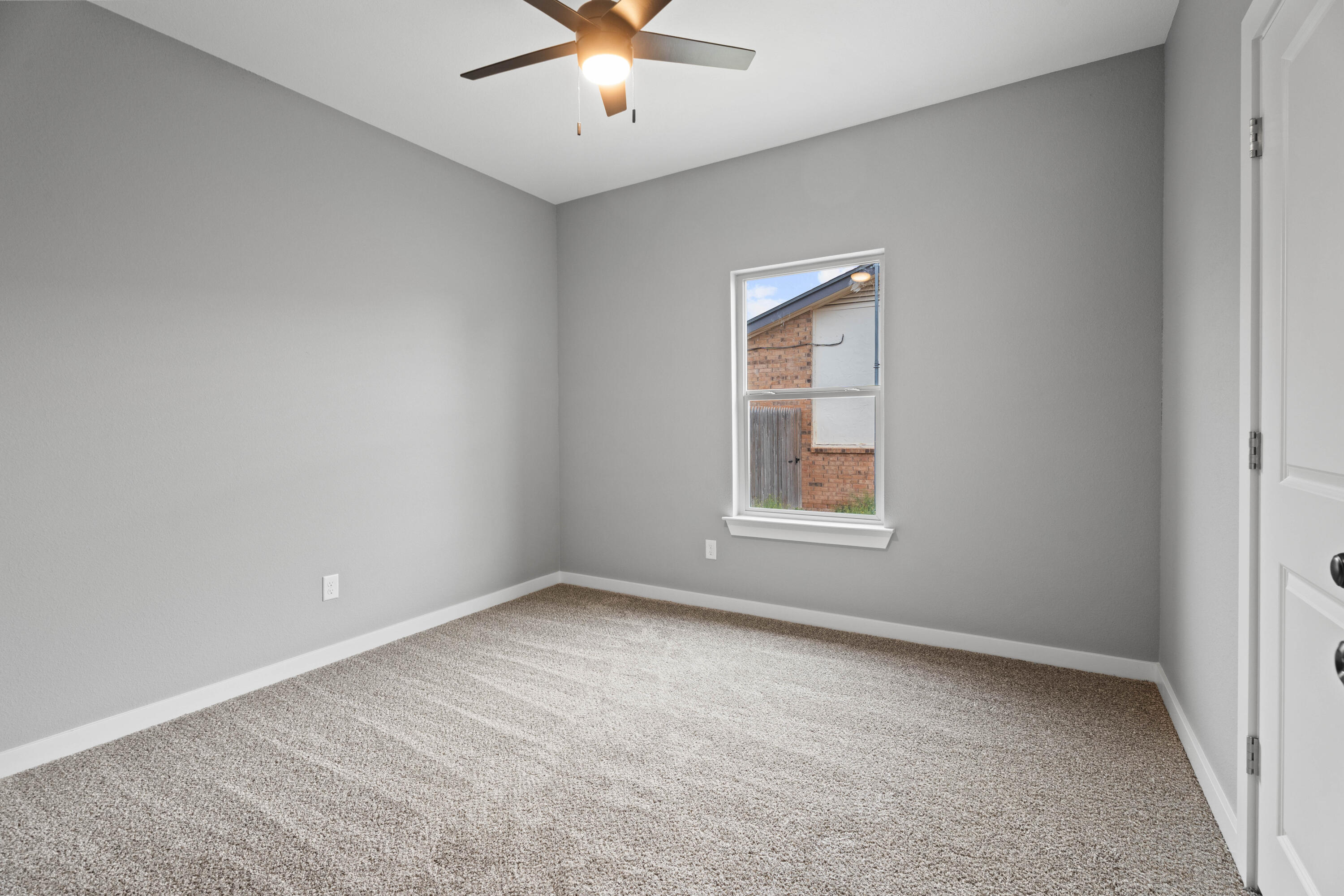 310 East 16th Street Wolfforth, TX 79382 - Photo 23 of 30 an empty room with chandelier fan and windows