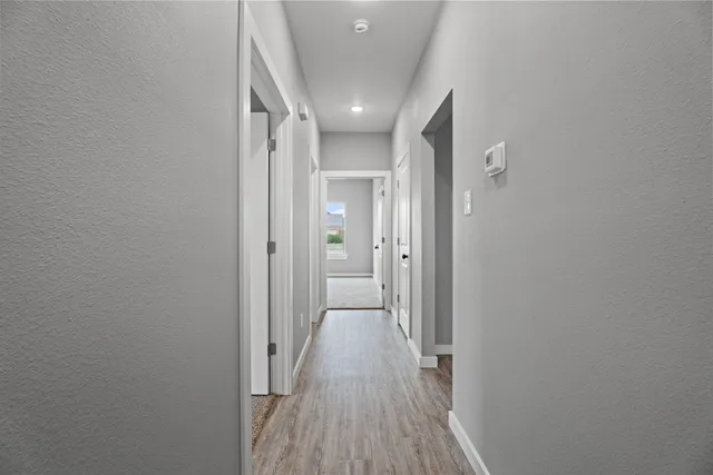 a view of hallway with wooden floor