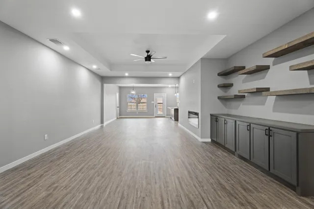 a view of a room with wooden floors and lots of counter top space