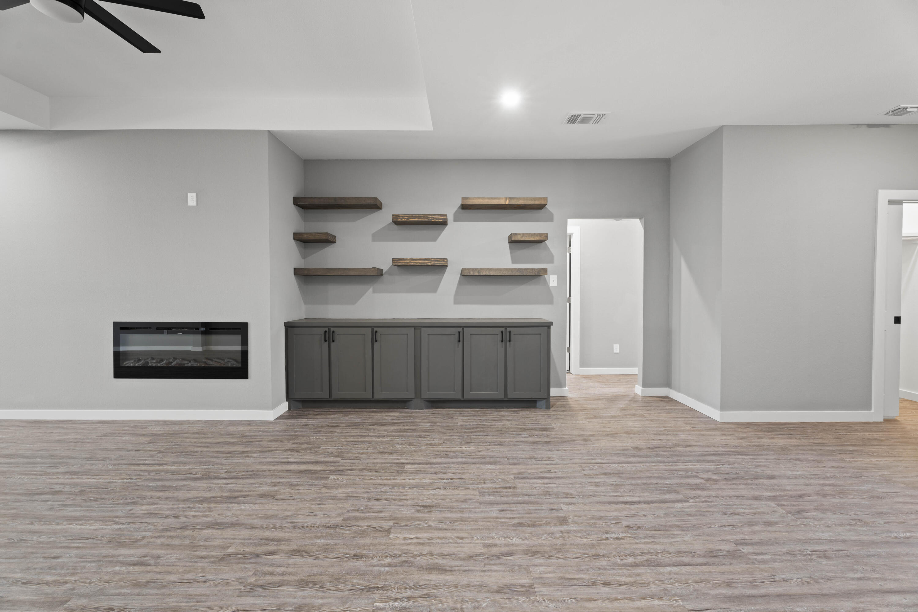 310 East 16th Street Wolfforth, TX 79382 - Photo 5 of 30 a view of a kitchen with stainless steel appliances wooden floor and living room