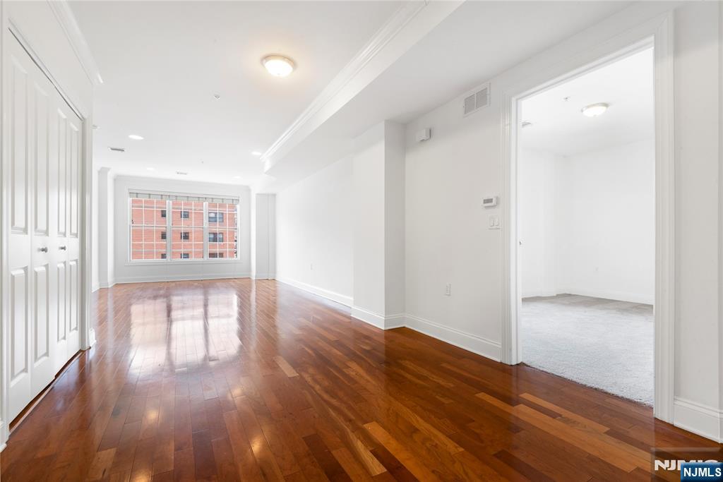 54 Polifly Road, Unit 311 Hackensack, NJ 07601 - Photo 6 of 20 a view of a hallway with wooden floor