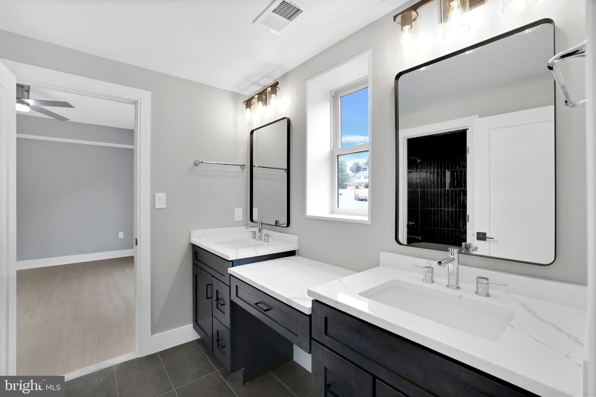 6226 Kellogg Drive McLean, VA 22101 - Photo 56 of 89 a bathroom with a double vanity sink and a mirror