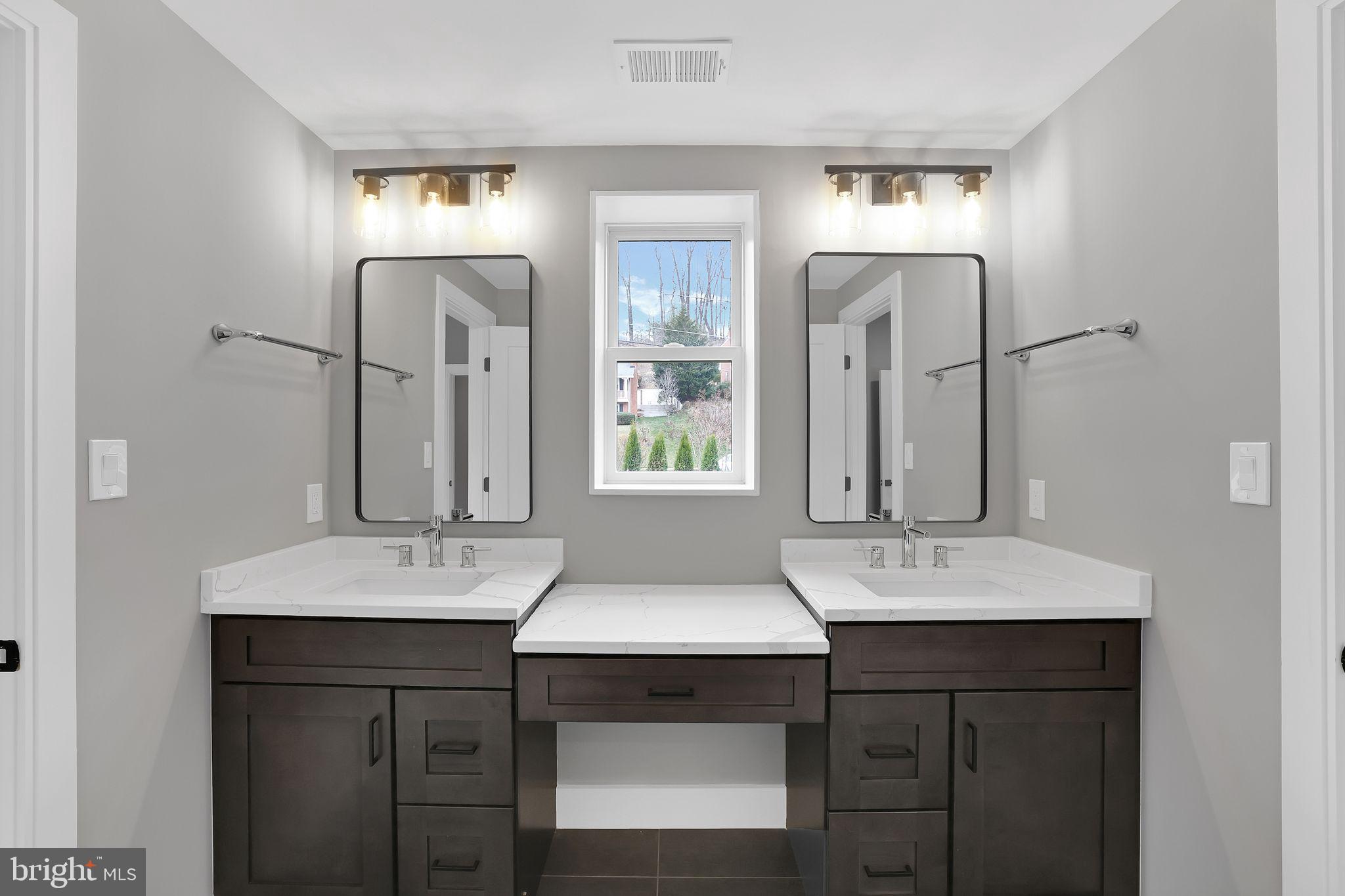 6226 Kellogg Drive McLean, VA 22101 - Photo 58 of 89 a bathroom with a sink vanity and a mirror