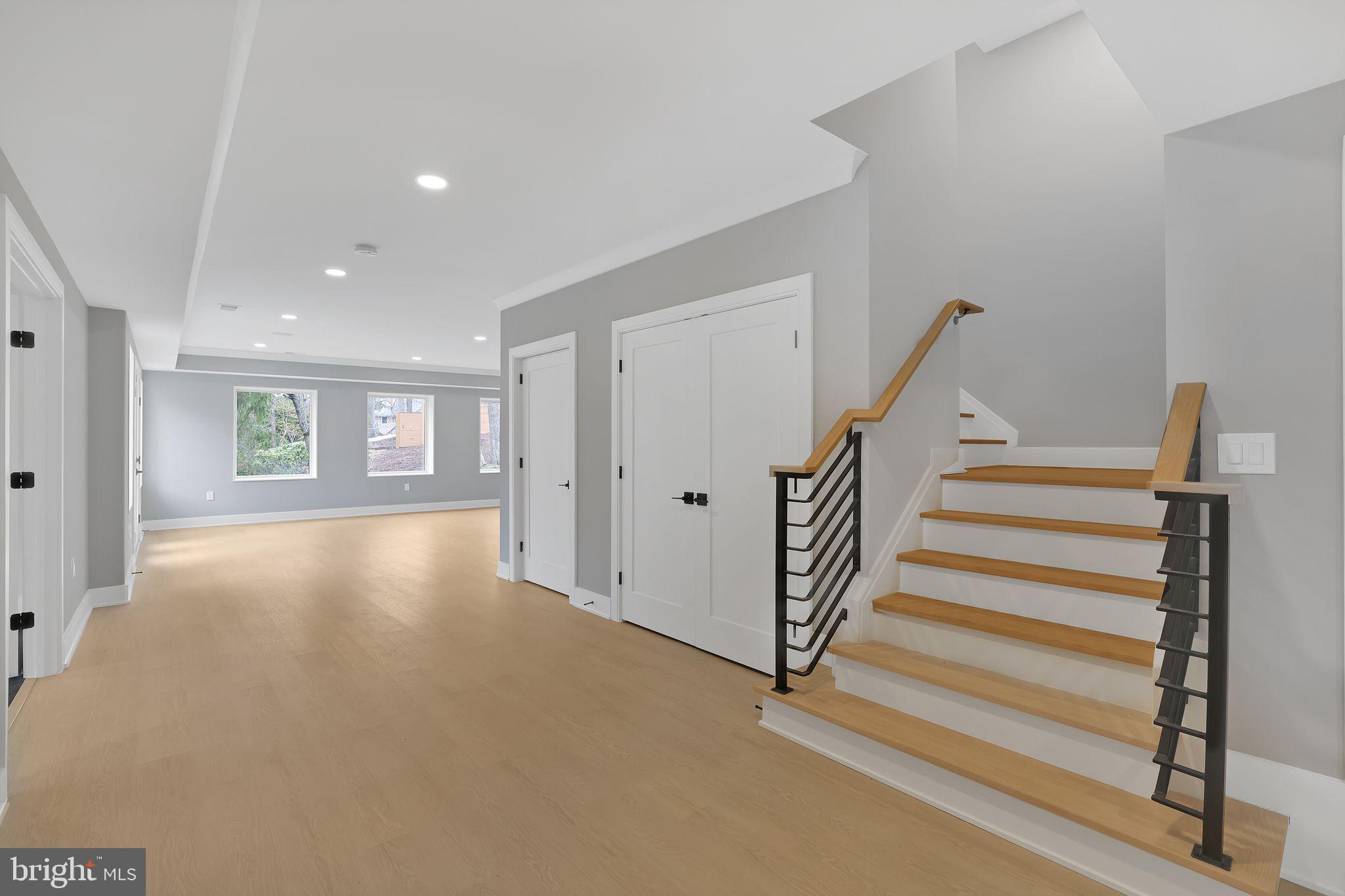 6226 Kellogg Drive McLean, VA 22101 - Photo 59 of 89 a view of an empty room with wooden floor and stairs