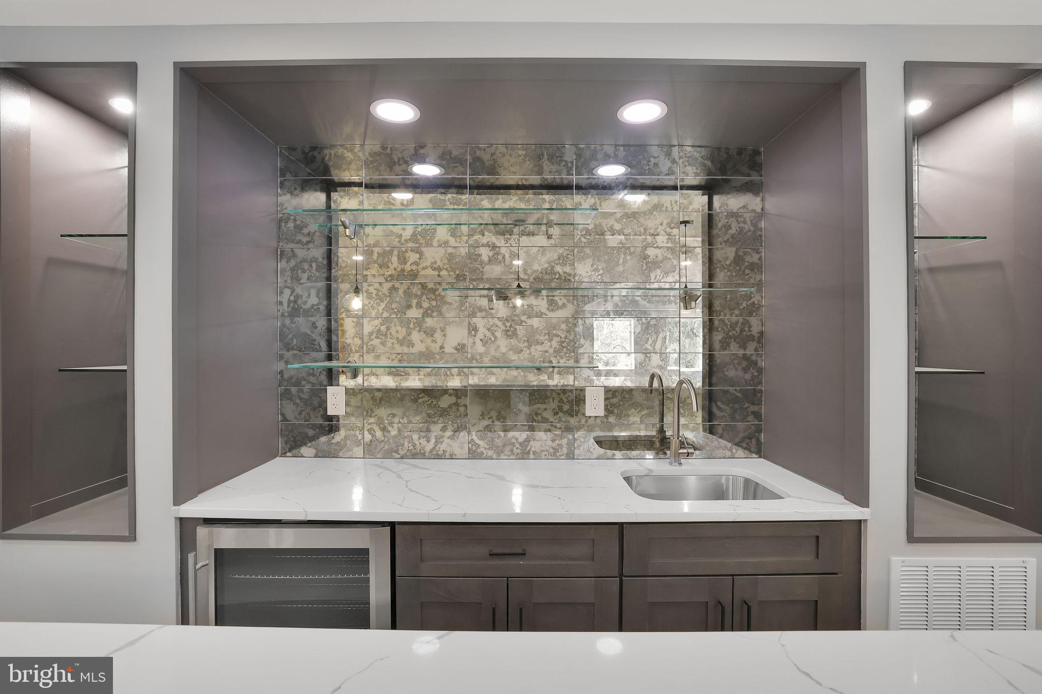 6226 Kellogg Drive McLean, VA 22101 - Photo 69 of 89 a bathroom with a sink a vanity a mirror and shower