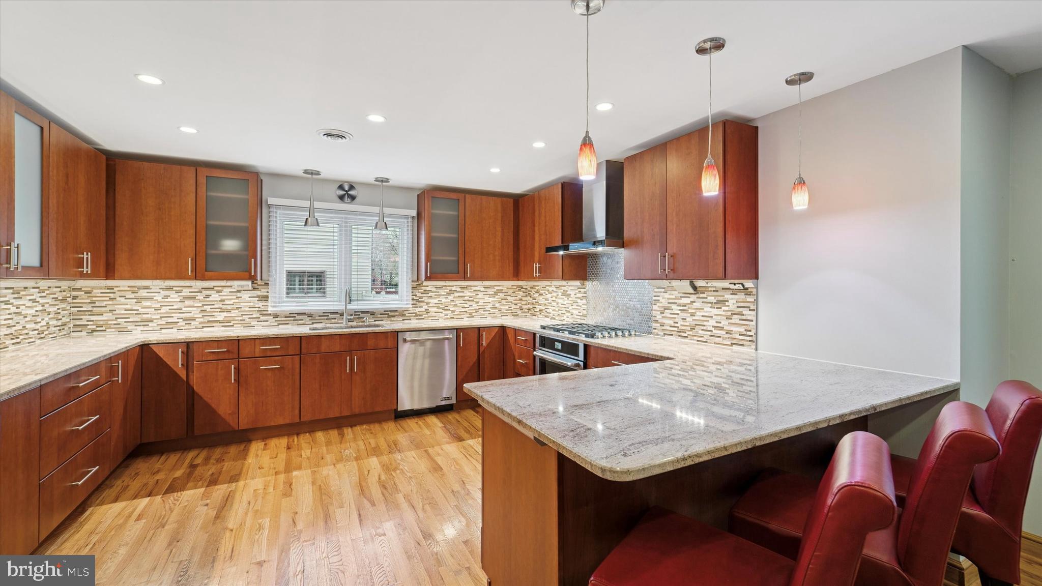 115 Union Mill Terrace Mount Laurel, NJ 08054 - Photo 11 of 31 a kitchen with stainless steel appliances kitchen island granite countertop a table chairs in it and wooden floors