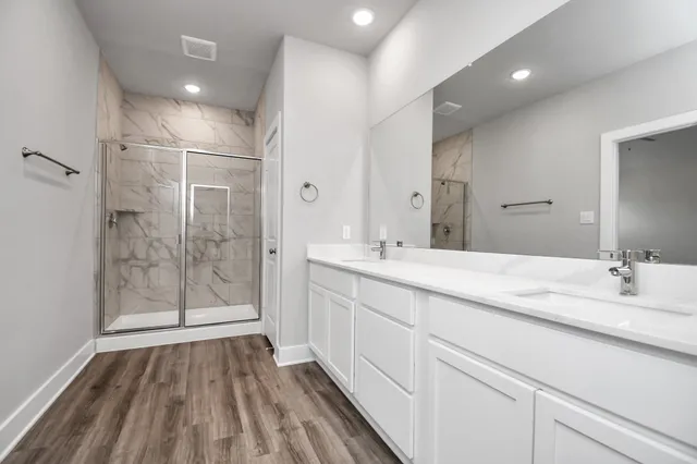 a bathroom with a double vanity sink and mirror
