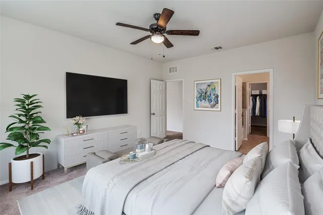 a bedroom with a bed and a flat screen tv