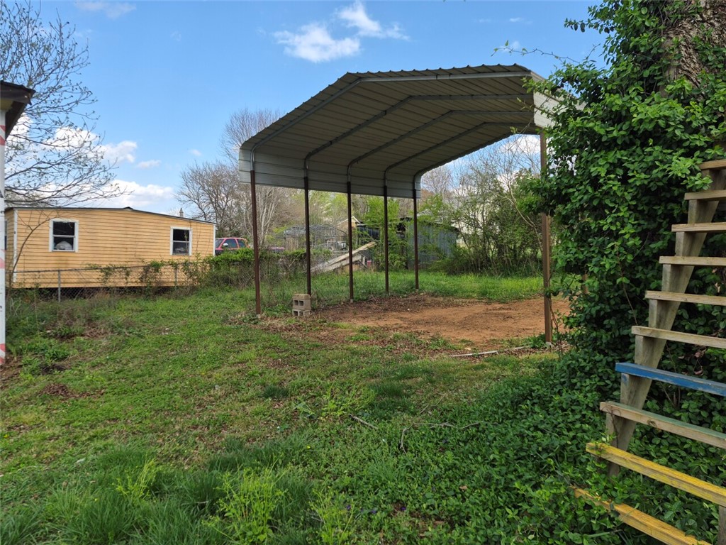 112 Overbrook Street Pickens, SC 29671 - Photo 8 of 19 This property features a spacious metal carport, offering practical outdoor storage and protection.