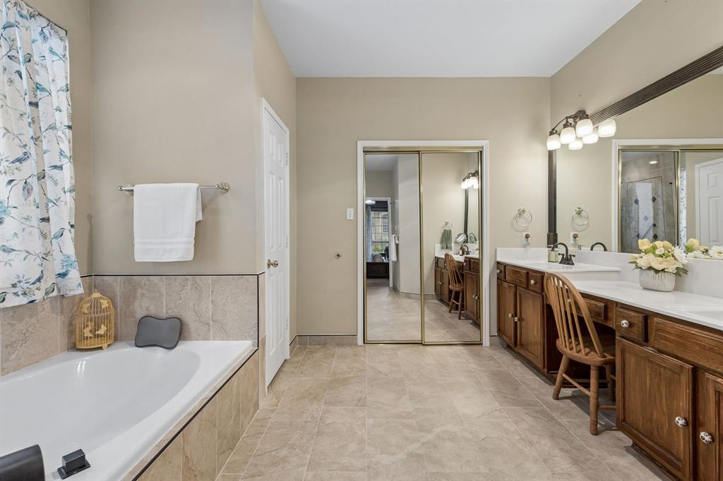 129 Timberbluff Lane Murphy, TX 75094 - Photo 19 of 34 a bathroom with a tub sink and mirror