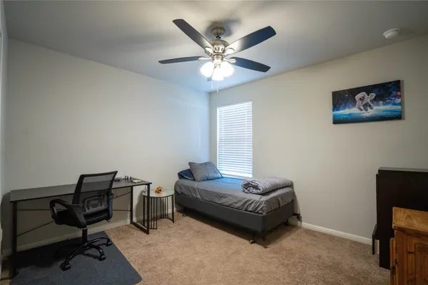 a living room with furniture and a ceiling fan
