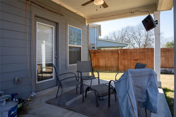 a front view of house with yard and trees in the background
