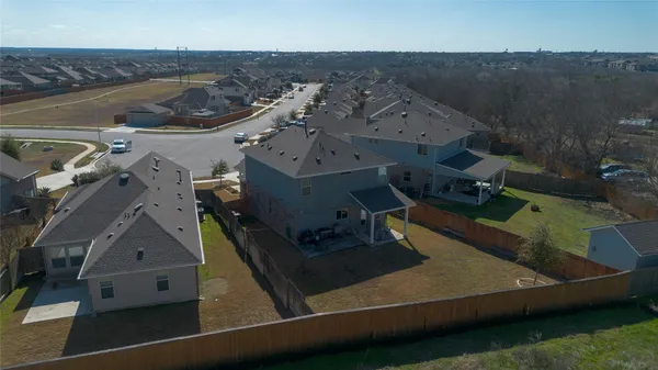 a view of a swimming pool with a yard and plants