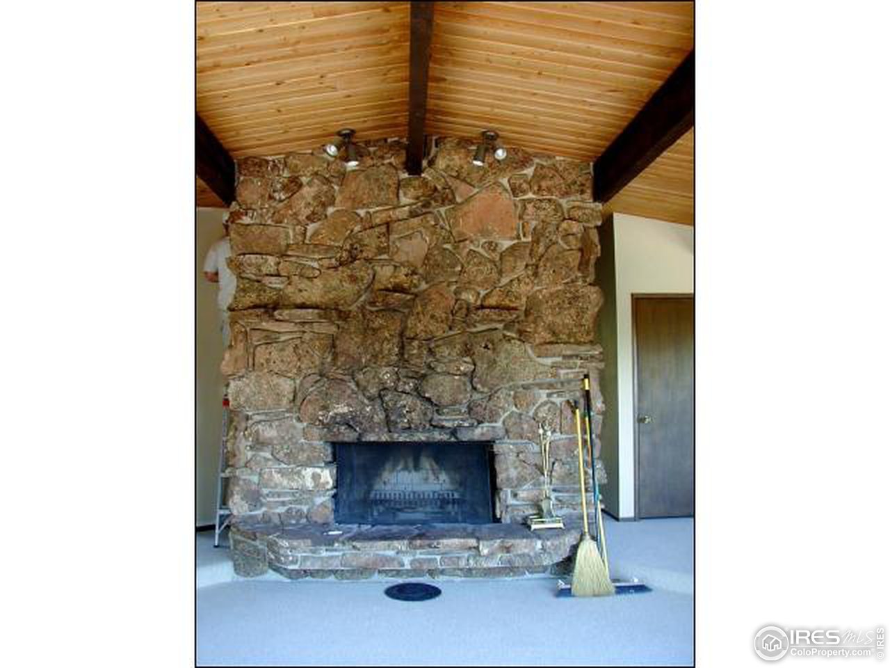 3032 Sugarloaf Road Boulder, CO 80302 - Photo 2 of 5 a living room with a fireplace