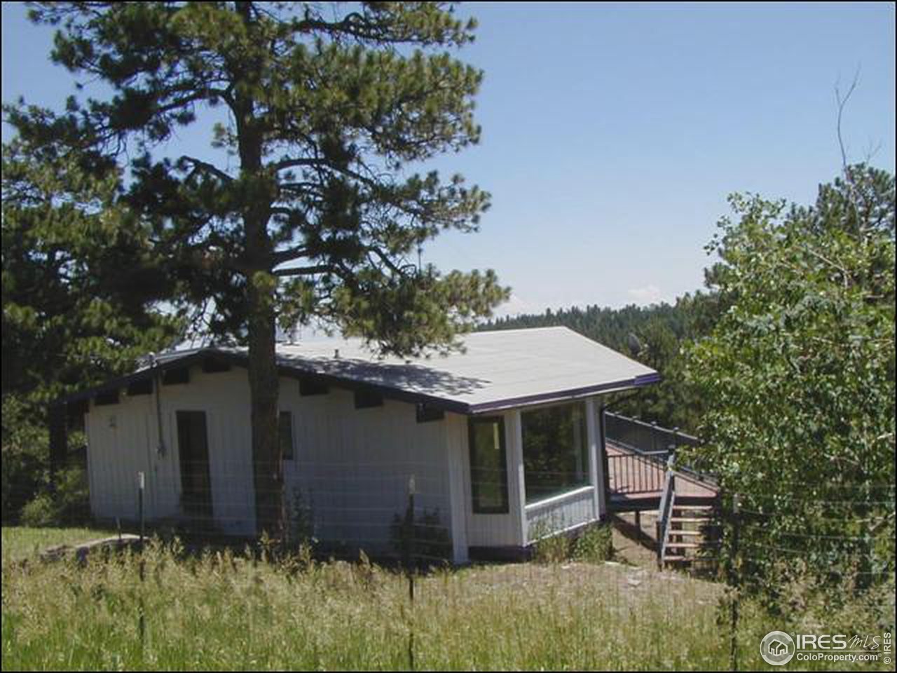 3032 Sugarloaf Road Boulder, CO 80302 - Photo 4 of 5 a view of a house with a yard plants and large tree