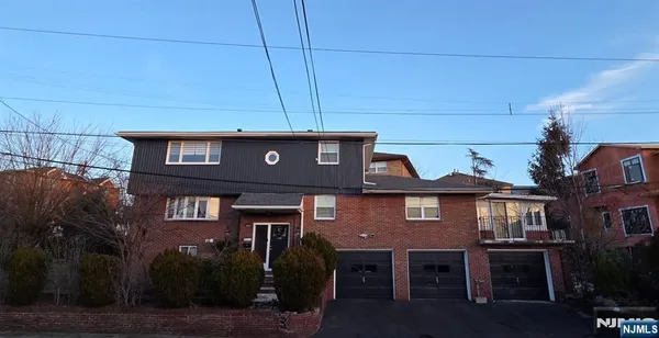 a front view of a houses with yard