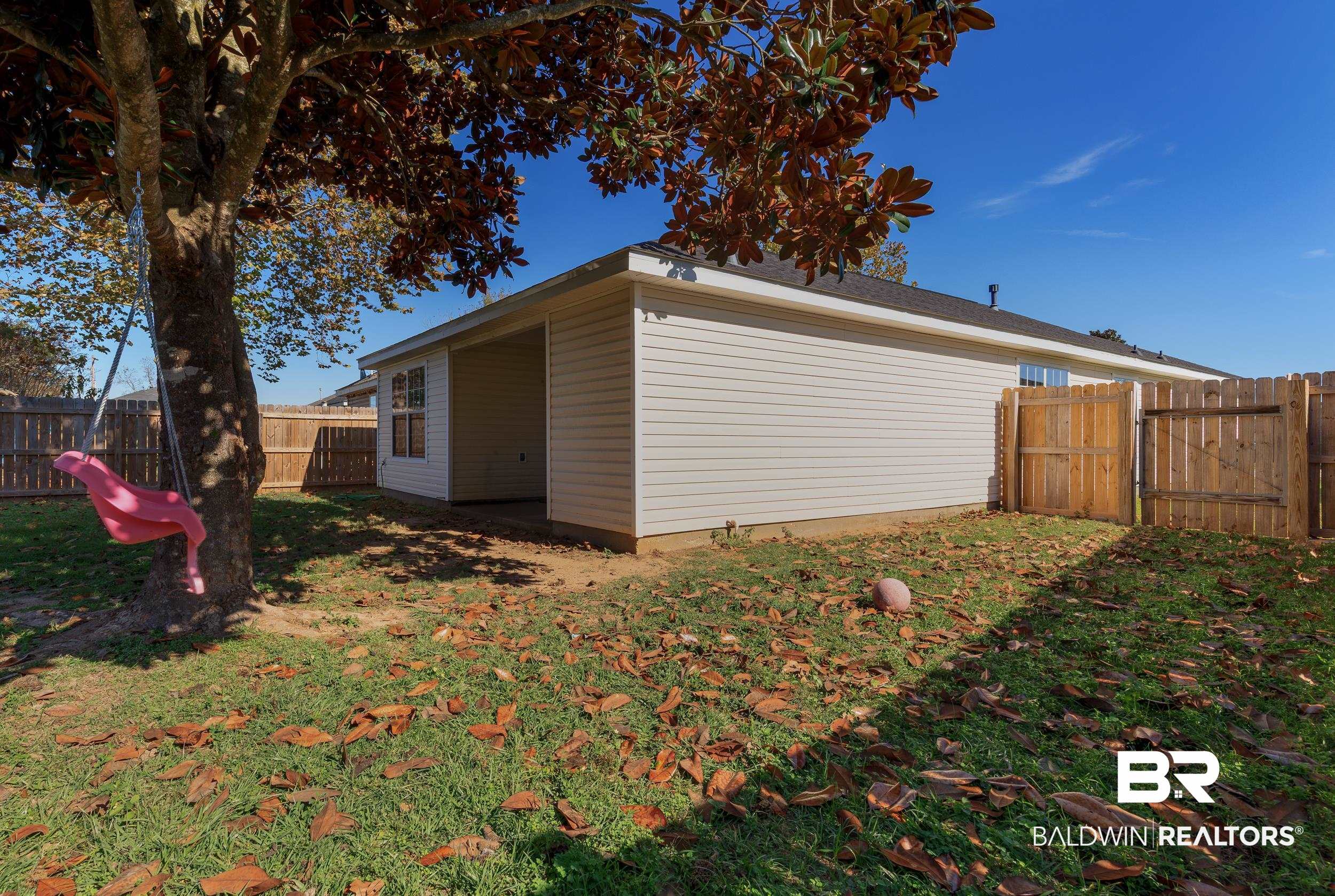 16227 Zenith Drive Loxley, AL 36551 - Photo 22 of 23 View of side of property with a fenced backyard