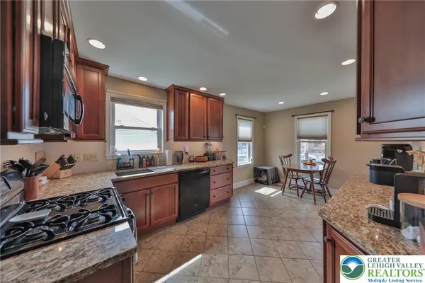 a large kitchen with lots of counter and chairs