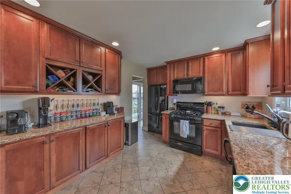a kitchen with stainless steel appliances a stove a refrigerator a sink and dishwasher