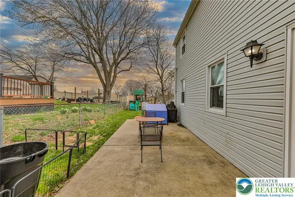 a house view with a garden and outdoor seating