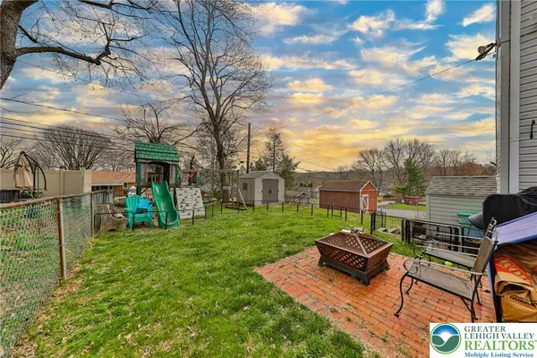 a view of a chairs and table in the back yard