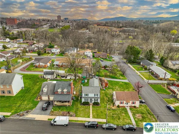 an aerial view of residential houses with outdoor space and river