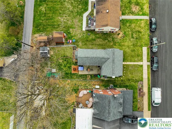an aerial view of a house with yard swimming pool and outdoor seating