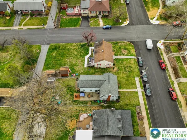 an aerial view of residential house with outdoor space and swimming pool