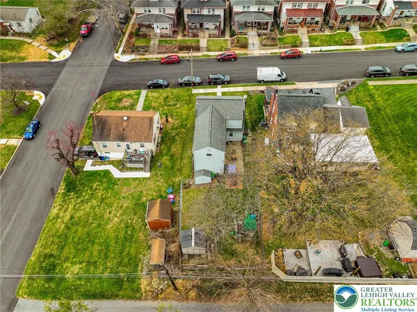an aerial view of residential houses with outdoor space