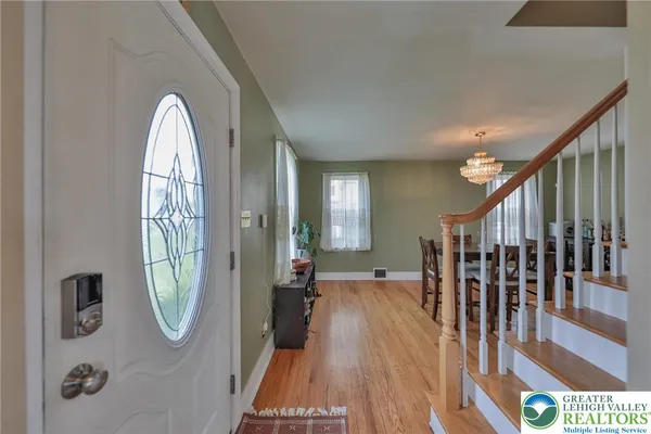 a view of an entryway with wooden floor