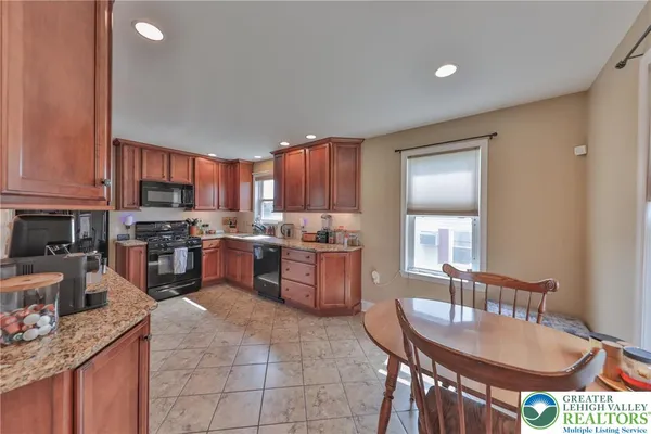 a kitchen with a stove a sink a microwave and a refrigerator