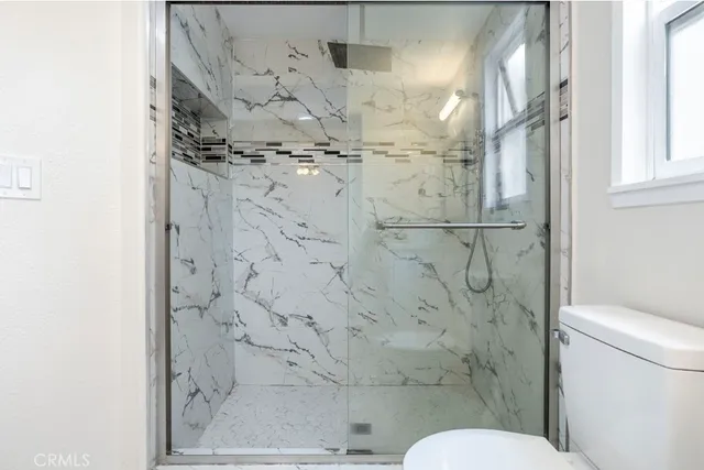 a bathroom with a toilet sink and shower