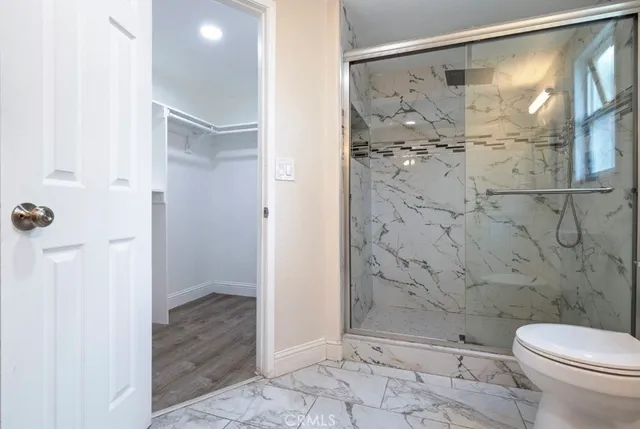a bathroom with a shower and a toilet
