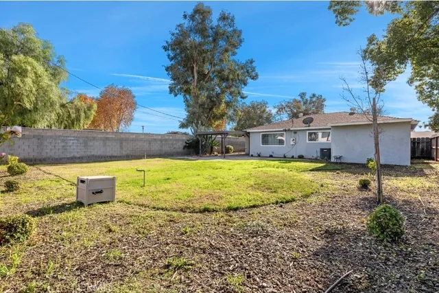 a swimming pool with outdoor seating and yard