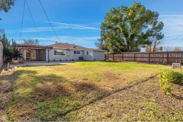 a front view of a house with a garden and yard